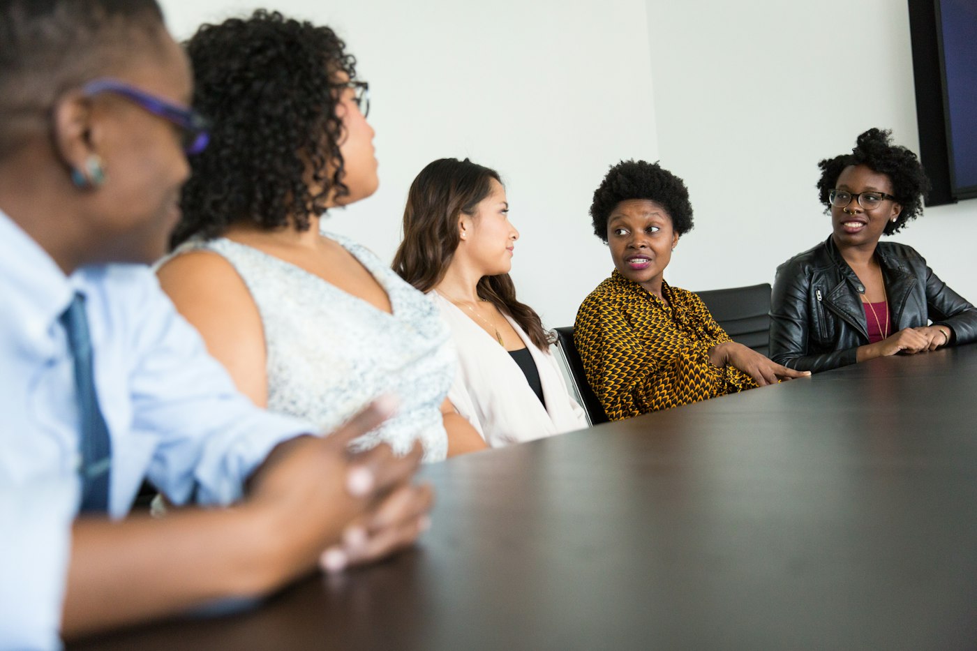 A diverse team talking around a table