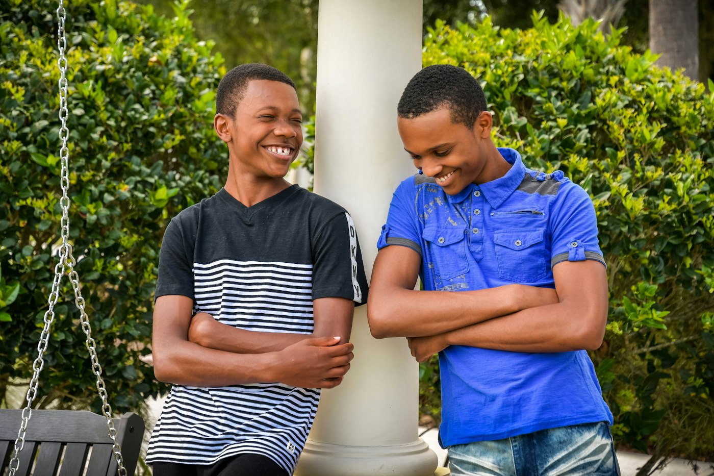 Two young people laughing together on a porch